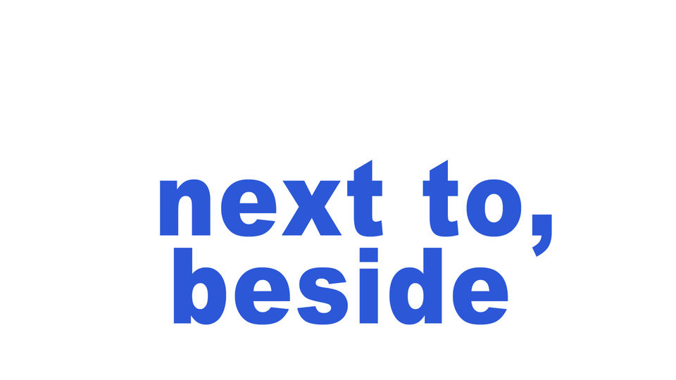 next to, beside